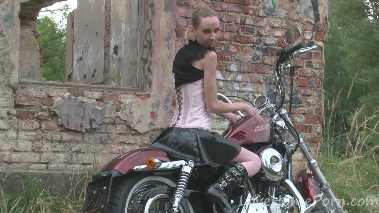 Cute teen 18+ is amazed by a big bike