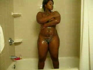 Ebony bitch with curves washes her brown twat in the shower