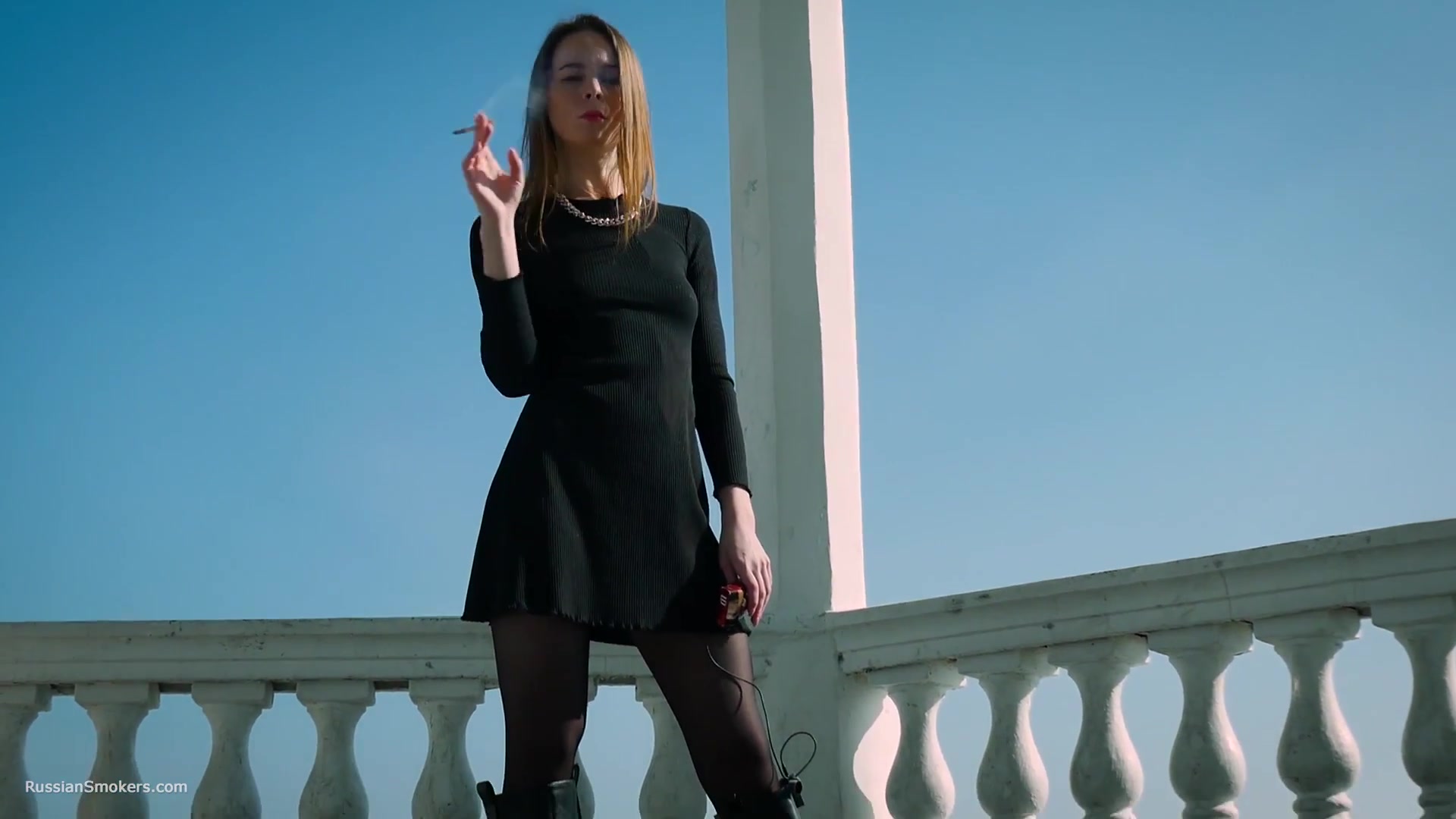 Slim Chick Basks In The Sun With A Cigarette In Her Hand