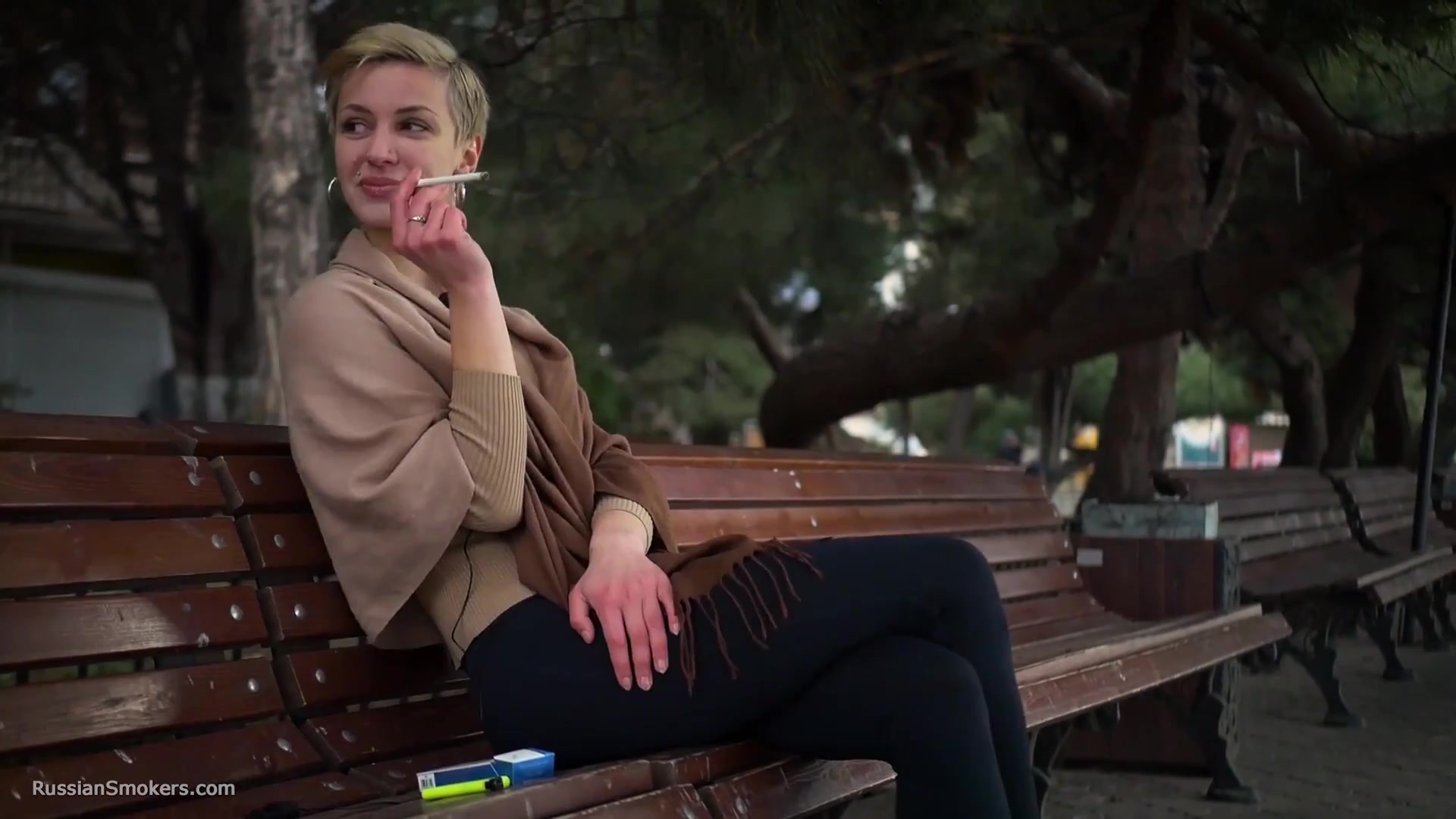 Short Cut Hair Blonde Girl Is Smoking All White 120mm Cigarettes