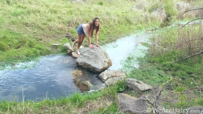 Charly orgasms as she masturbates by her creek
