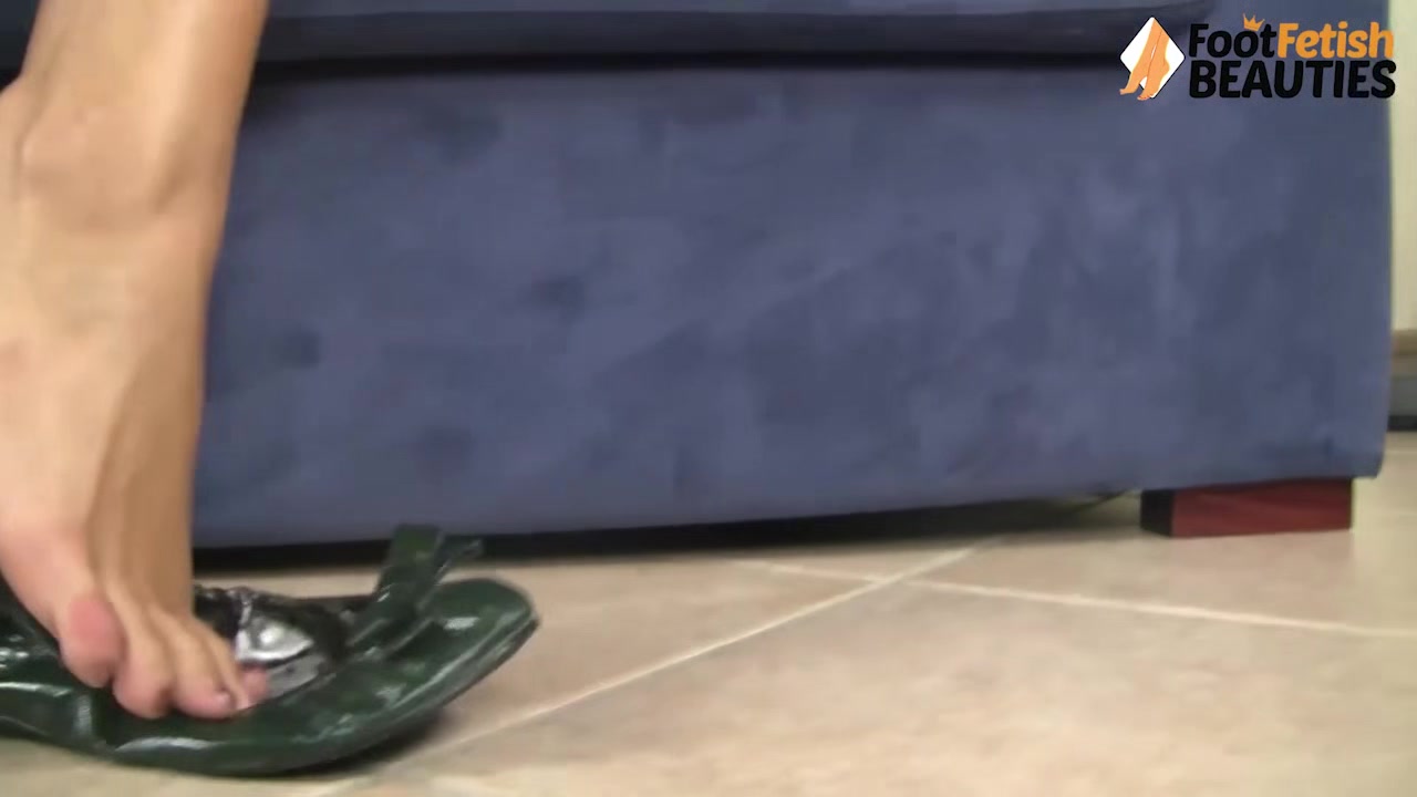 Girl dangles her ballet flats from the top of the toes