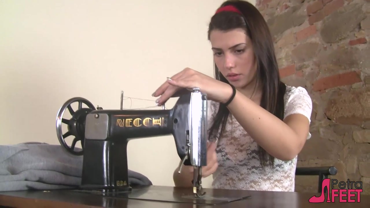 Leggy Petra pumping a vintage sewing machine pedal with her pantyhosed feet
