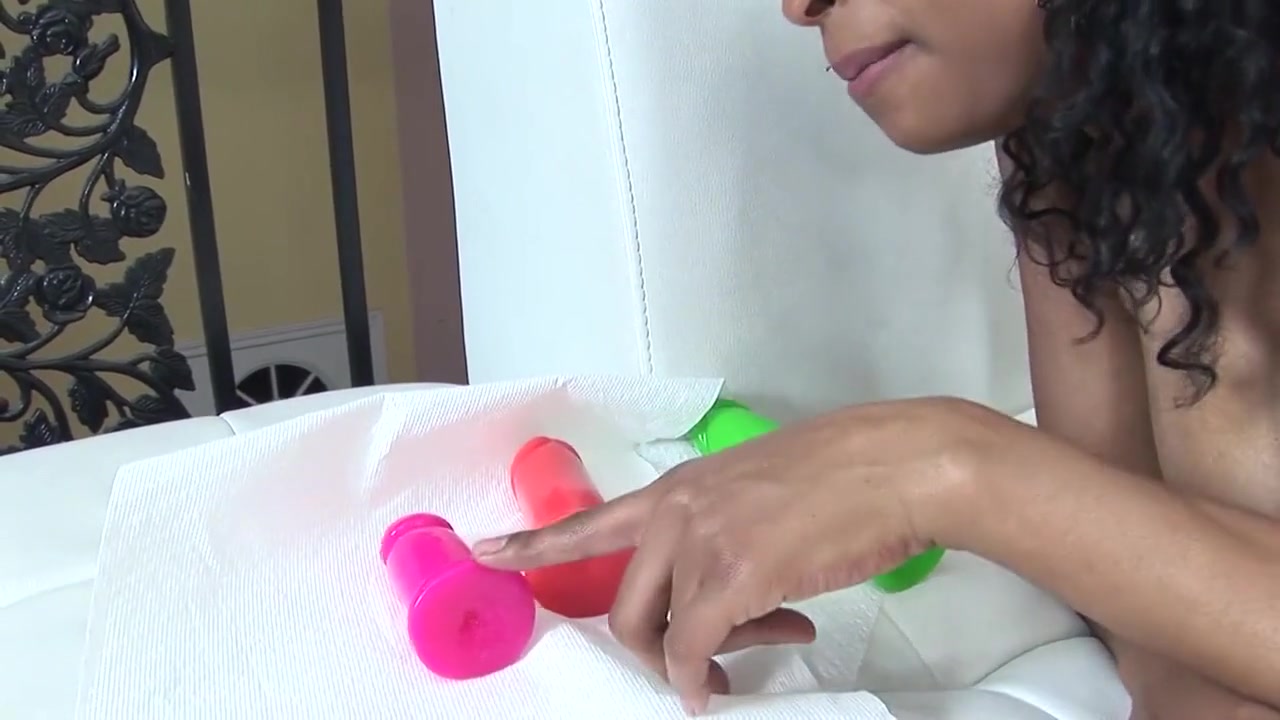 Two black women with huge tits play with toys on the couch
