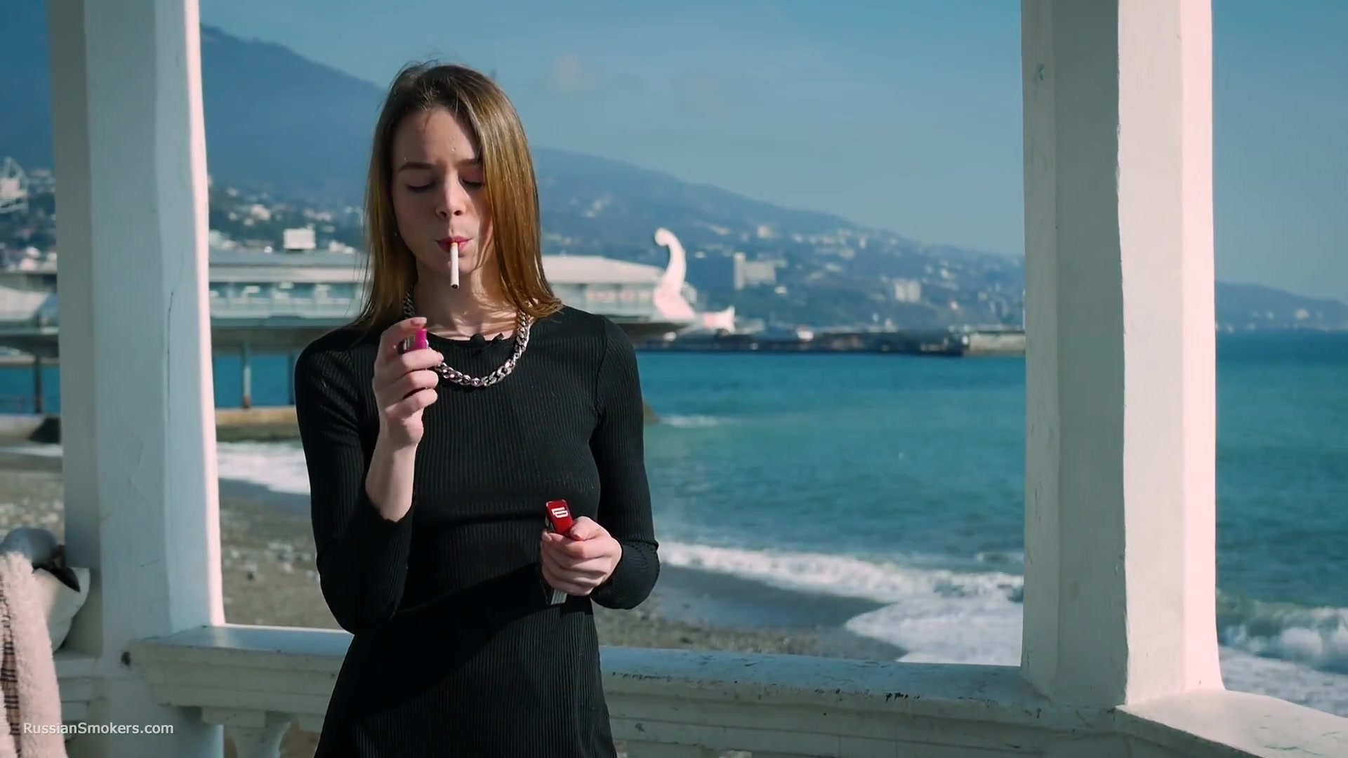 Slim Chick Basks In The Sun With A Cigarette In Her Hand