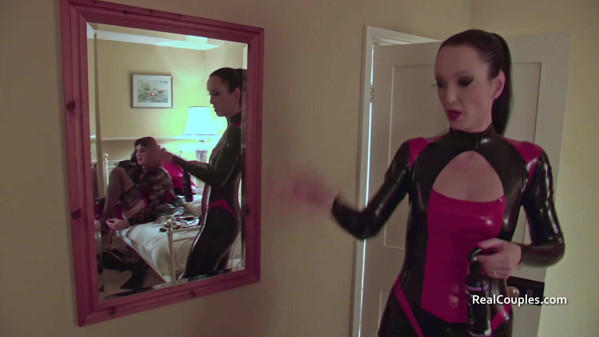 Cross dressing husband with PVC clad wife