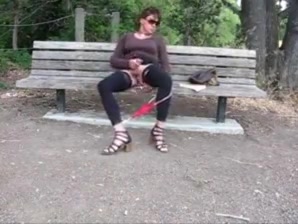 Lovely crossdresser jerks it on a park bench