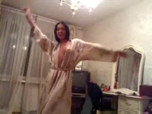 Brunette pussycat strips playfully in a nightdress