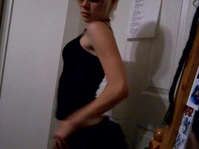 Short-haired blonde girl dances in the homemade video