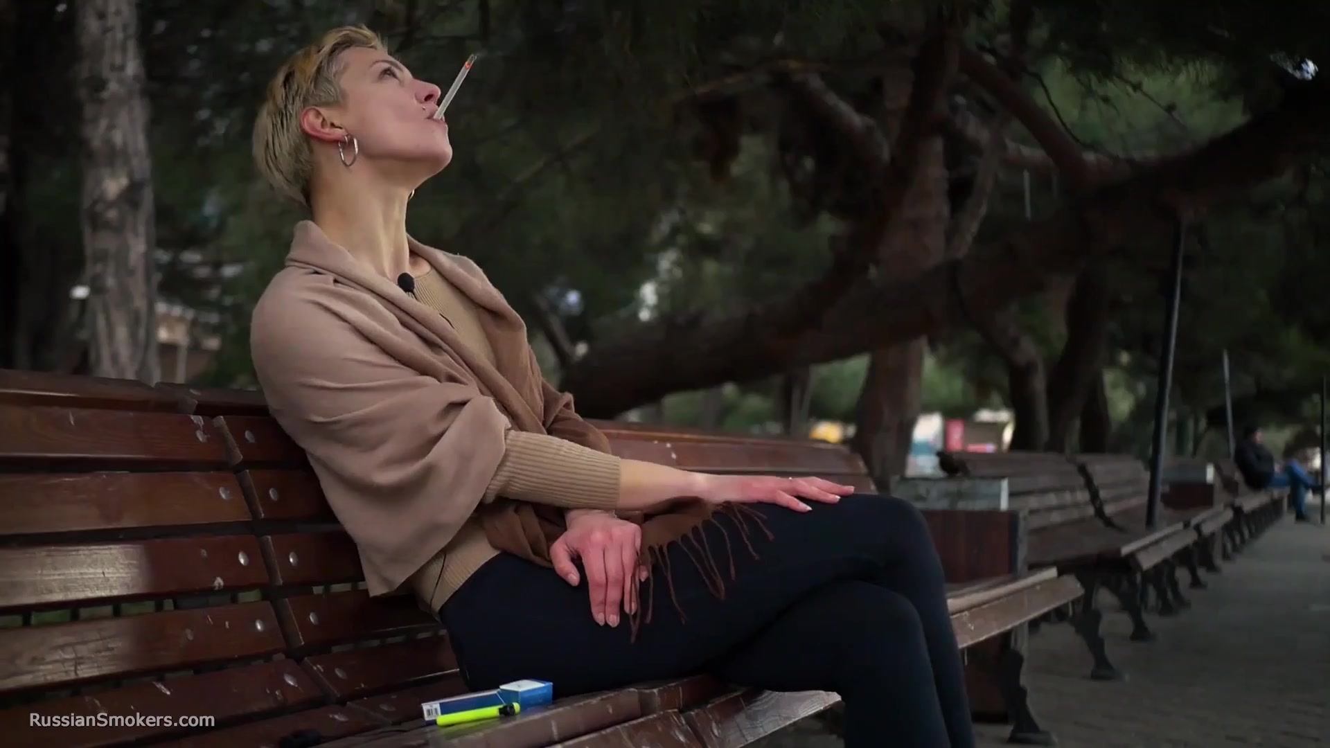 Short Cut Hair Blonde Girl Is Smoking All White 120mm Cigarettes
