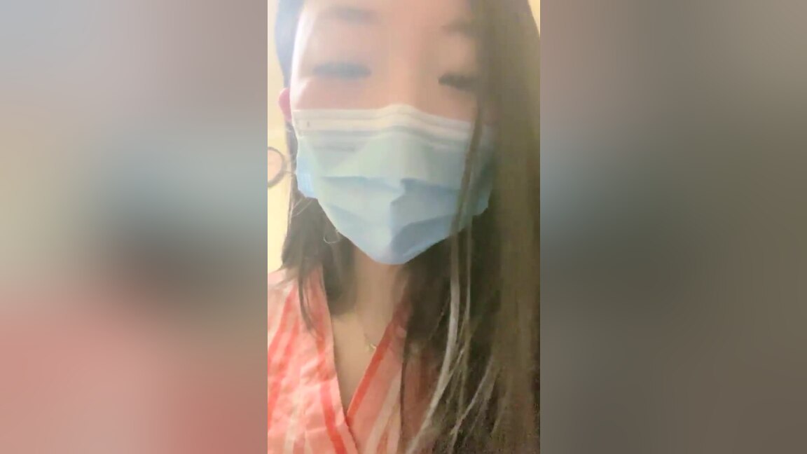 An Asian woman is seen urinating on in a public washroom
