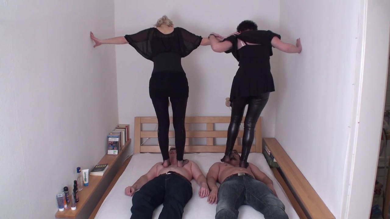 Brunette and blonde are trampling on their slaves by Femdom Austria