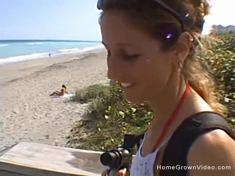 Handjob from busty brunette on beach
