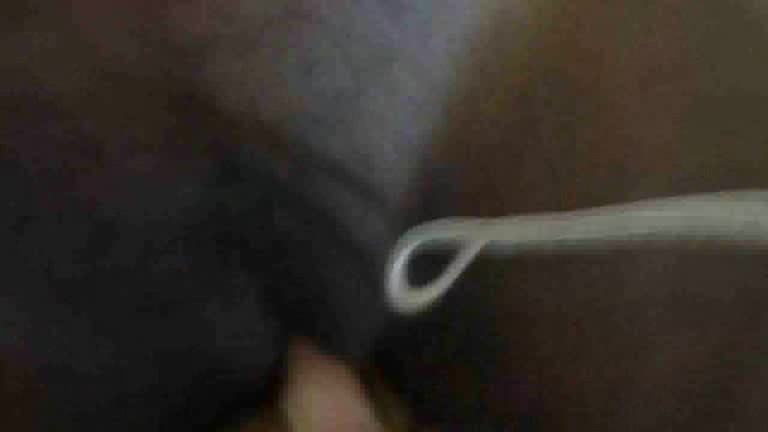 Black skinned girl has something inside her pussy