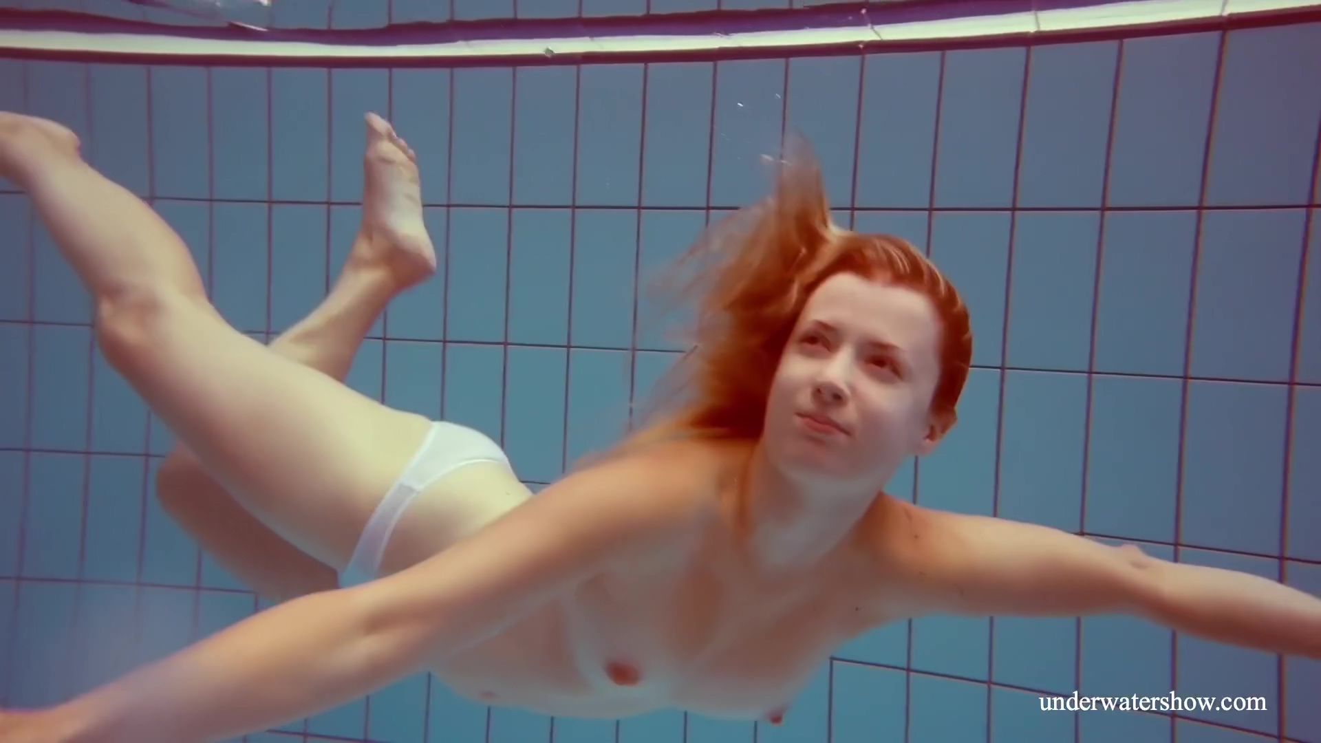 In The Indoor Pool, A Stunning Girl Swims