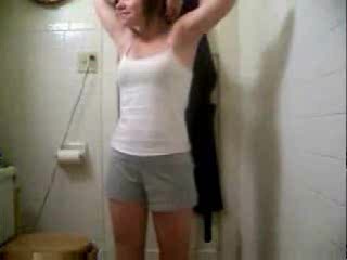 Small-titted babe dances and strips to the music