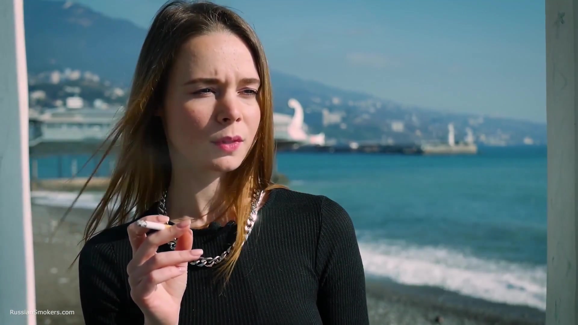 Slim Chick Basks In The Sun With A Cigarette In Her Hand