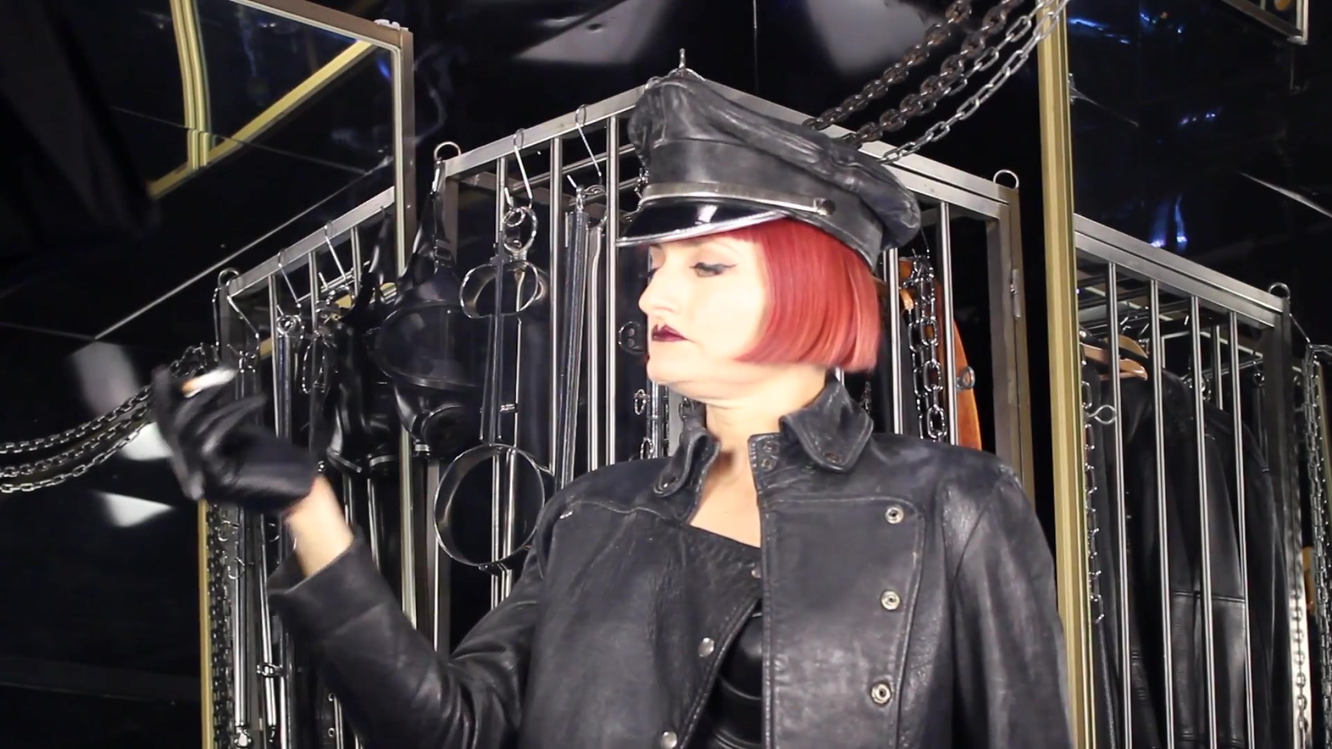 Mistress Tokyo Smoking Cigarette In Leather, Gloves And Muir Cap