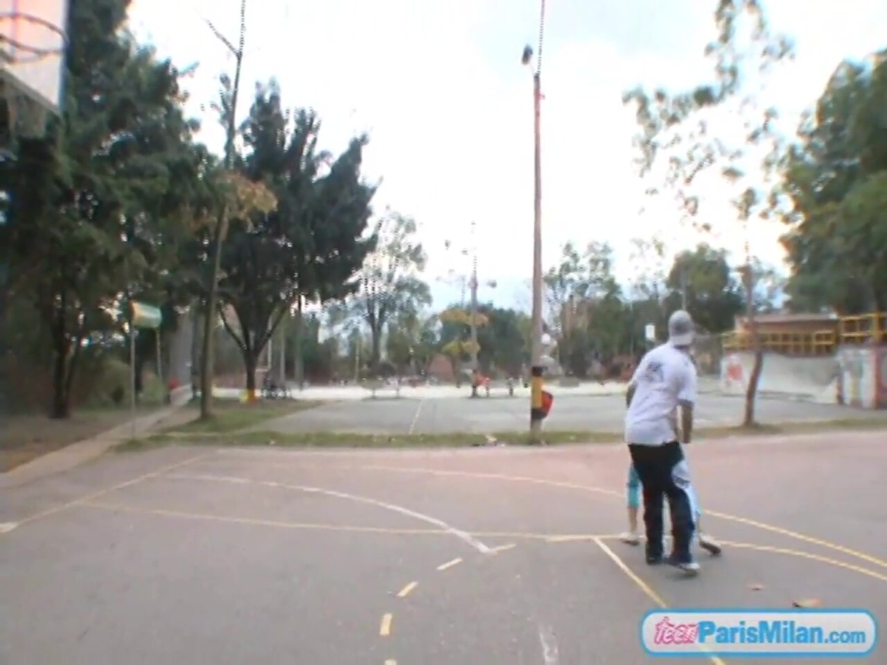 Paris Milan plays basketball outdoors
