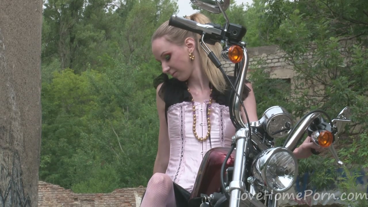 Cute teen 18+ is amazed by a big bike