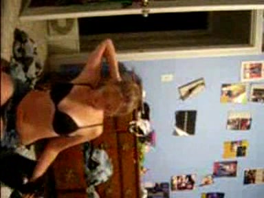 Blonde young girl taking her clothes off slowly