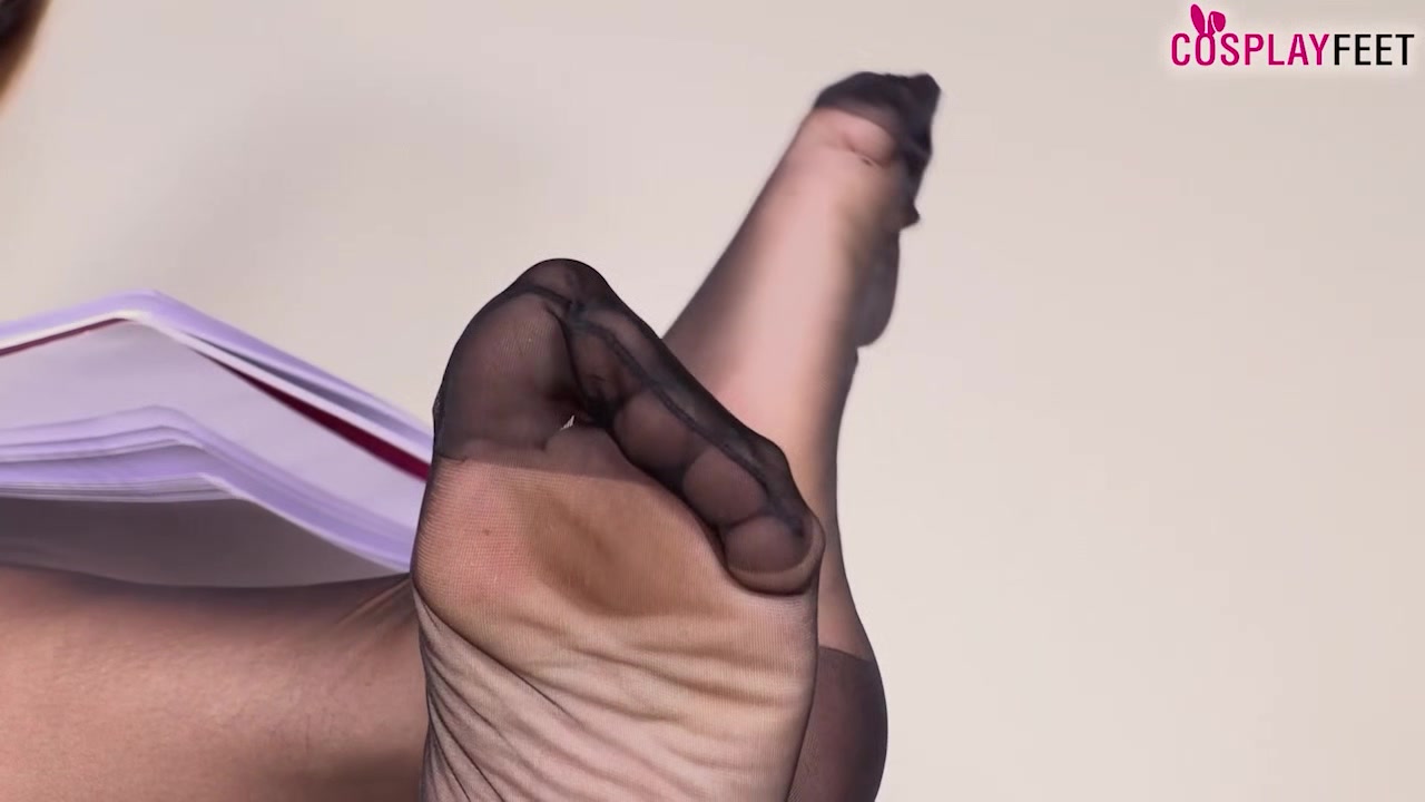 College girl in tights shoeplay and feet on the desk
