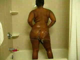 Ebony bitch with curves washes her brown twat in the shower