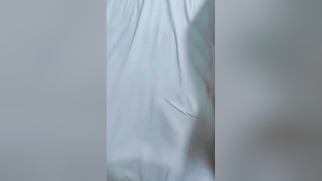 At home, an isolated Asian couple participates in doggystyle sex.