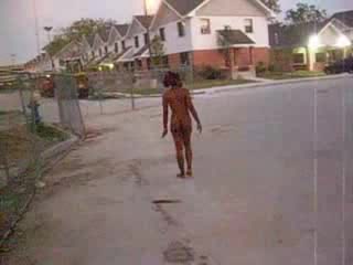 Curly black slut walks naked around the neighborhood