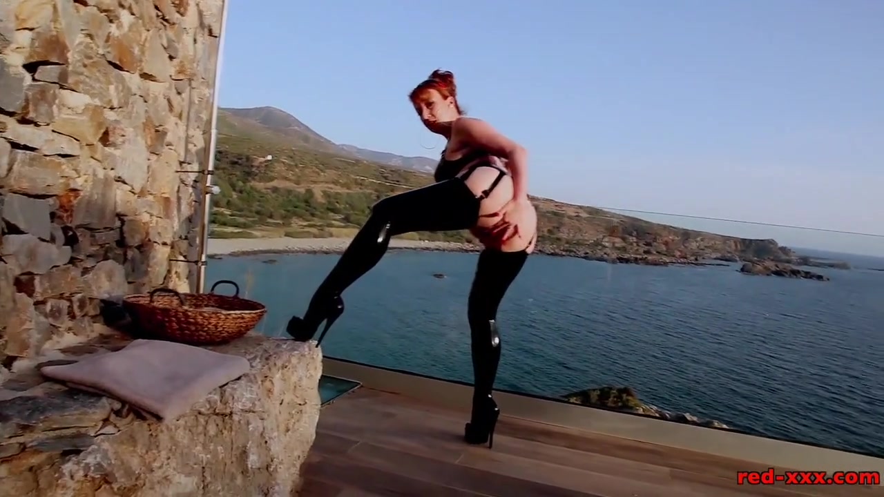 Mature British redhead masturbates on the balcony