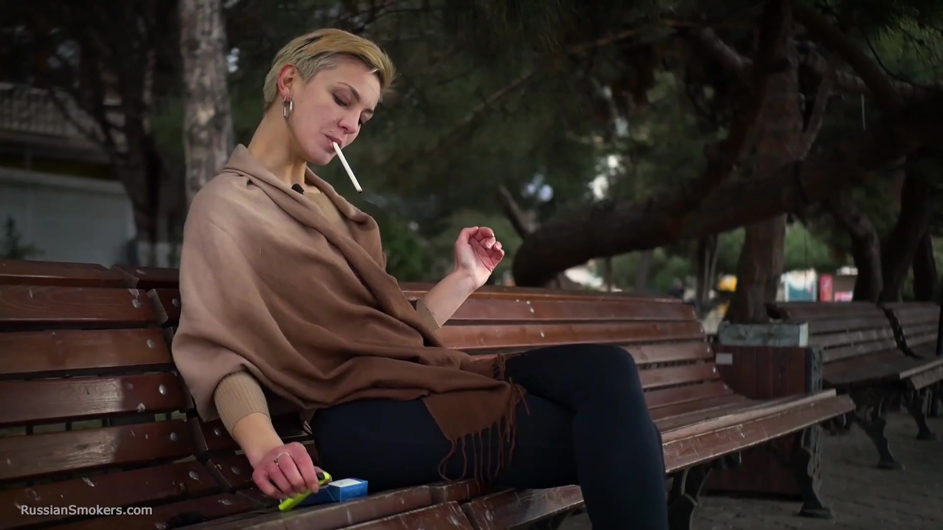 Short Cut Hair Blonde Girl Is Smoking All White 120mm Cigarettes