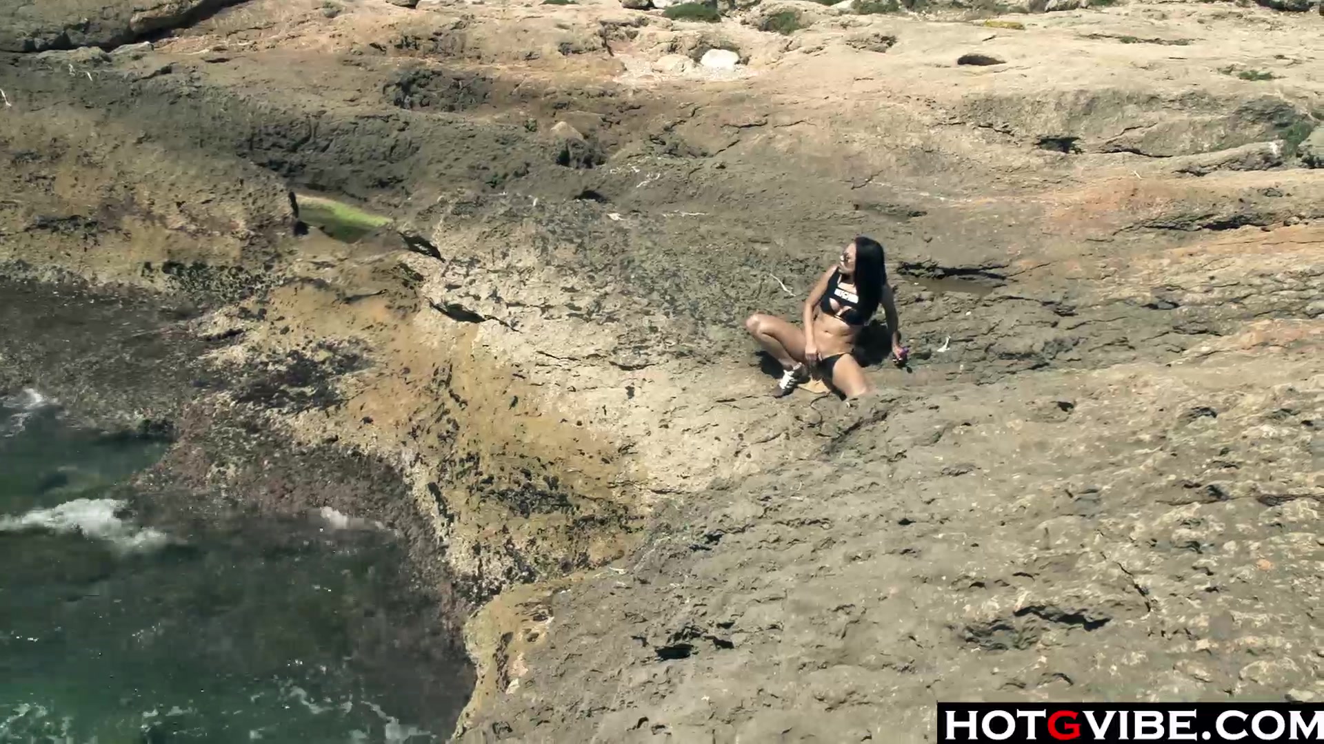 Slim Spanish Latina fucks herself on the beach