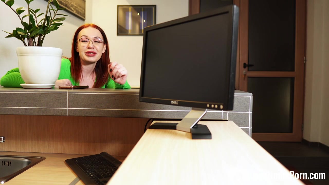 Fucking a redhead behind her working desk