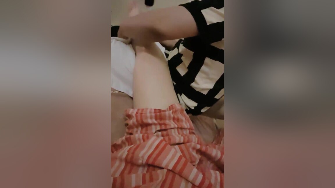 An Asian woman is seen urinating on in a public washroom