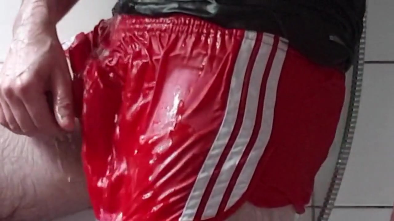showering in red Adidas shiny vintage shorts