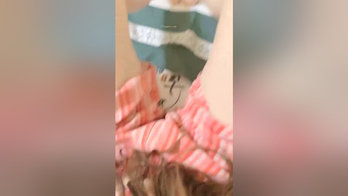 An Asian woman is seen urinating on in a public washroom