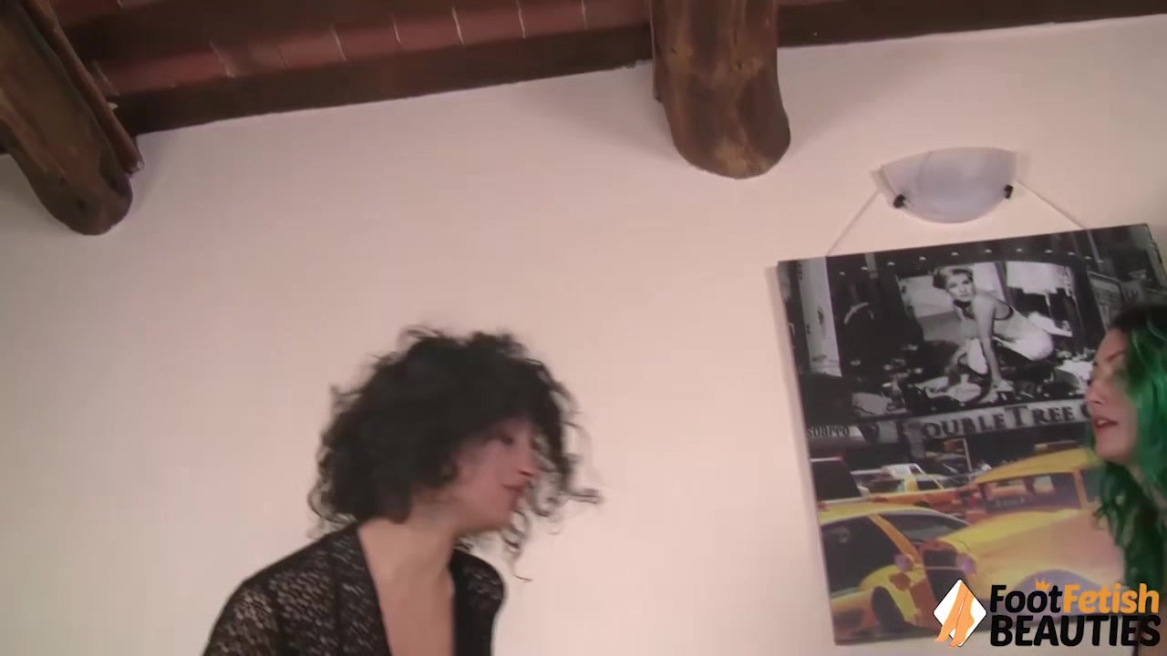 Two barefoot lesbians takes heels off and play footsies