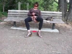 Lovely crossdresser jerks it on a park bench