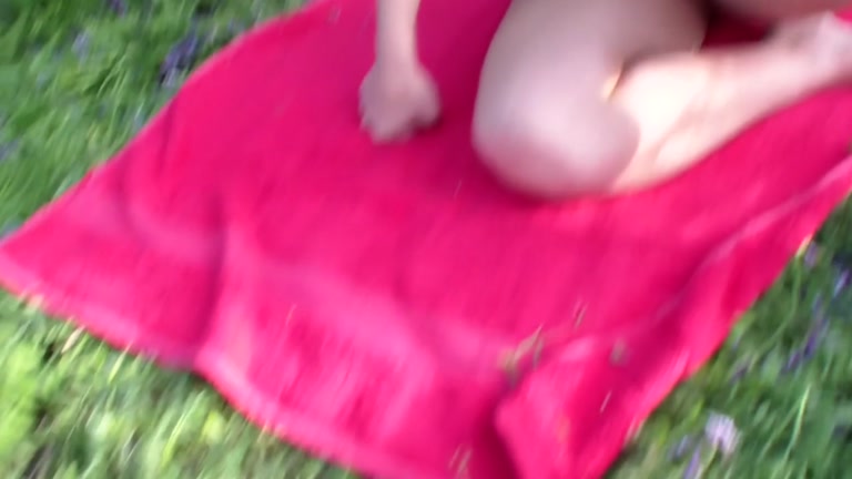 A blossoming meadow and undressed pair fucking in the centre