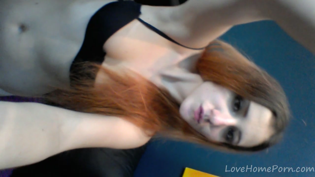 Redhead in a red dress rubs her pussy