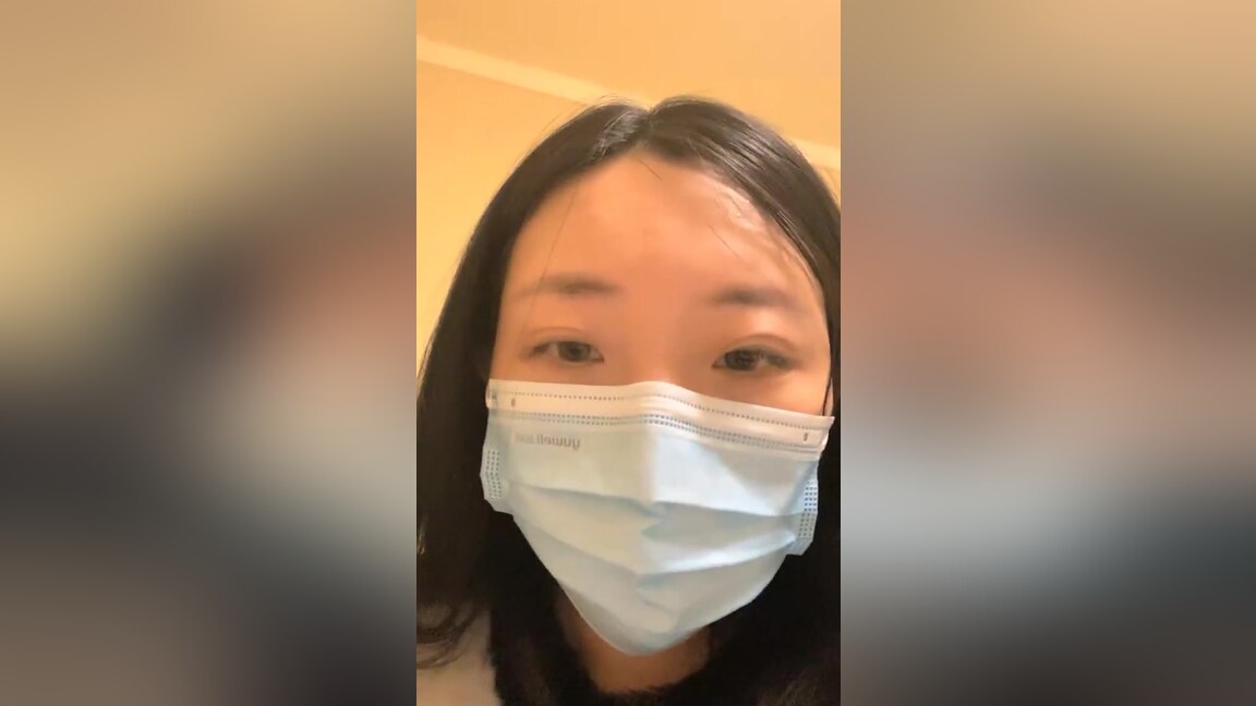 An Asian woman is seen urinating on in a public washroom