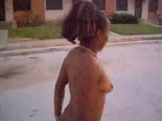 Curly black slut walks naked around the neighborhood