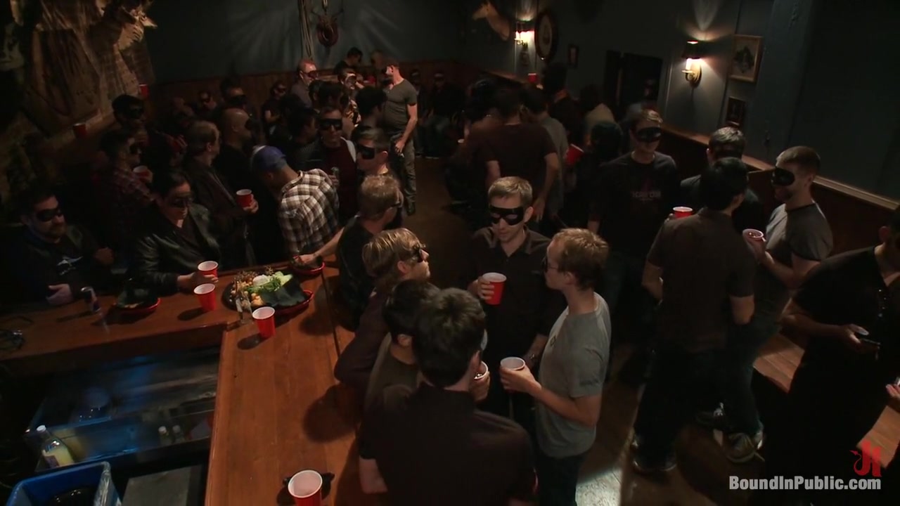 Captured stud is being used in a bar full of horny masked men