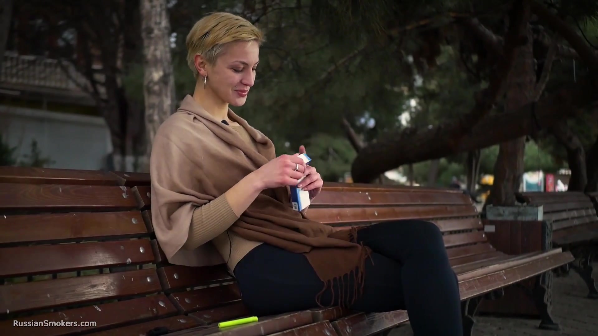 Short Cut Hair Blonde Girl Is Smoking All White 120mm Cigarettes