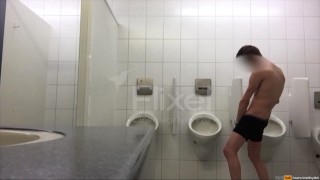 Exhibitionist boy is pissing in a urinoir - long gif video