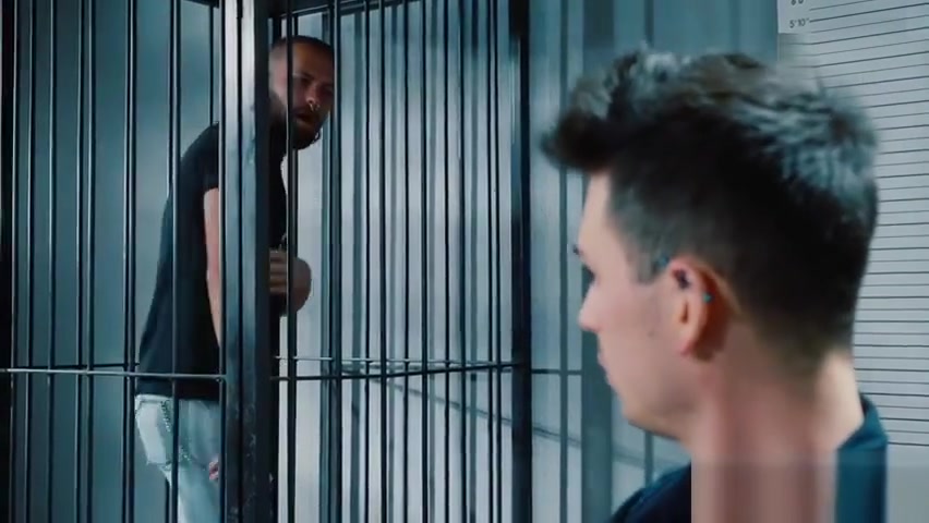 Prisoner pulling his jeans down for the officer on duty