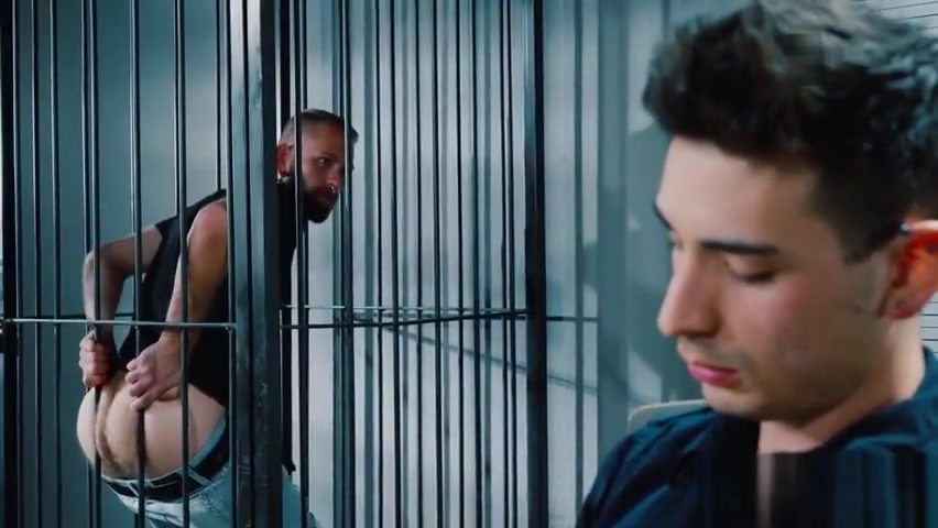 Prisoner pulling his jeans down for the officer on duty