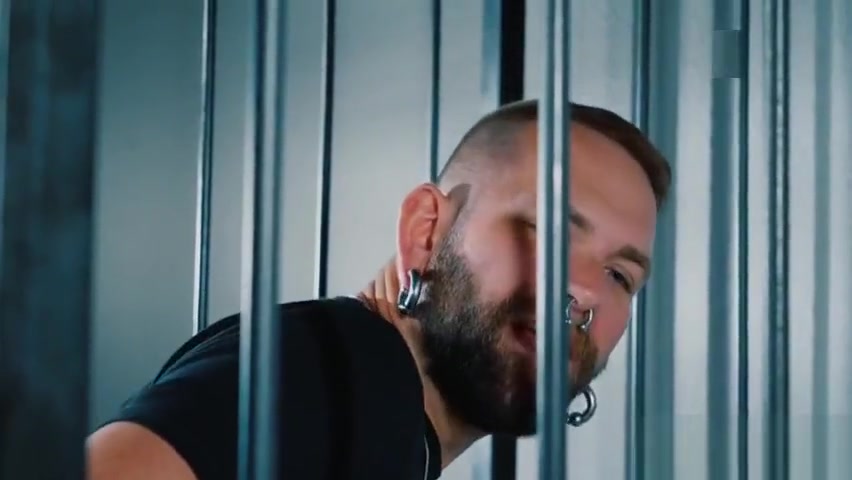 Prisoner pulling his jeans down for the officer on duty