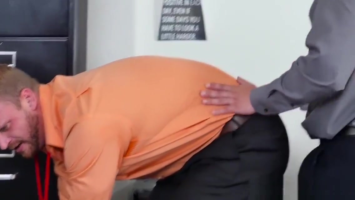 Muscular stud pounds bloke on office desk