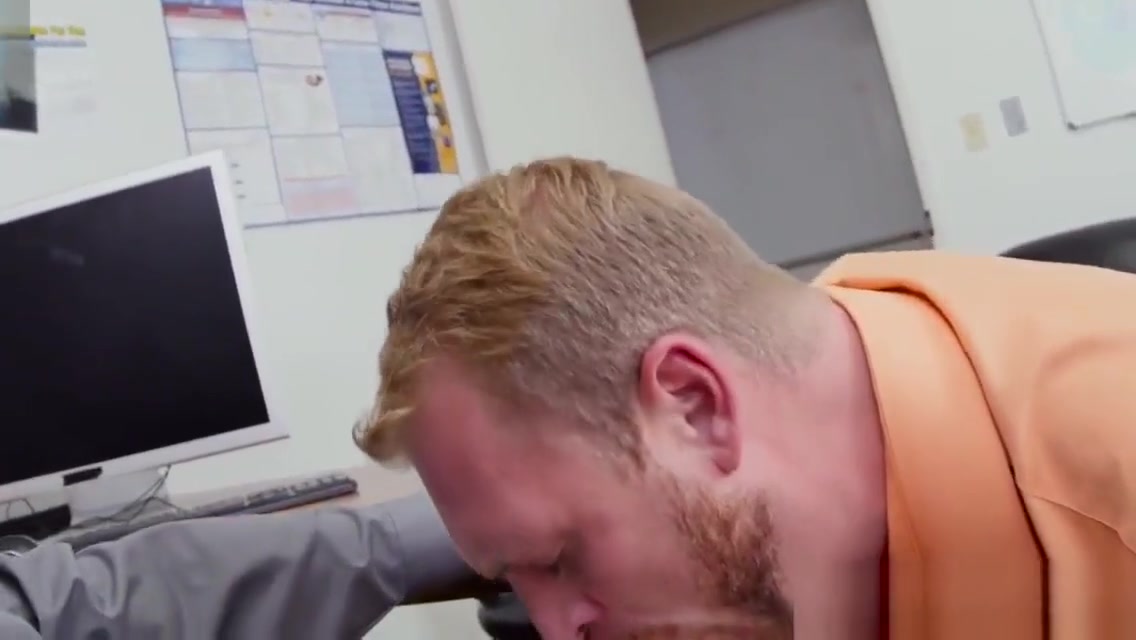 Muscular stud pounds bloke on office desk